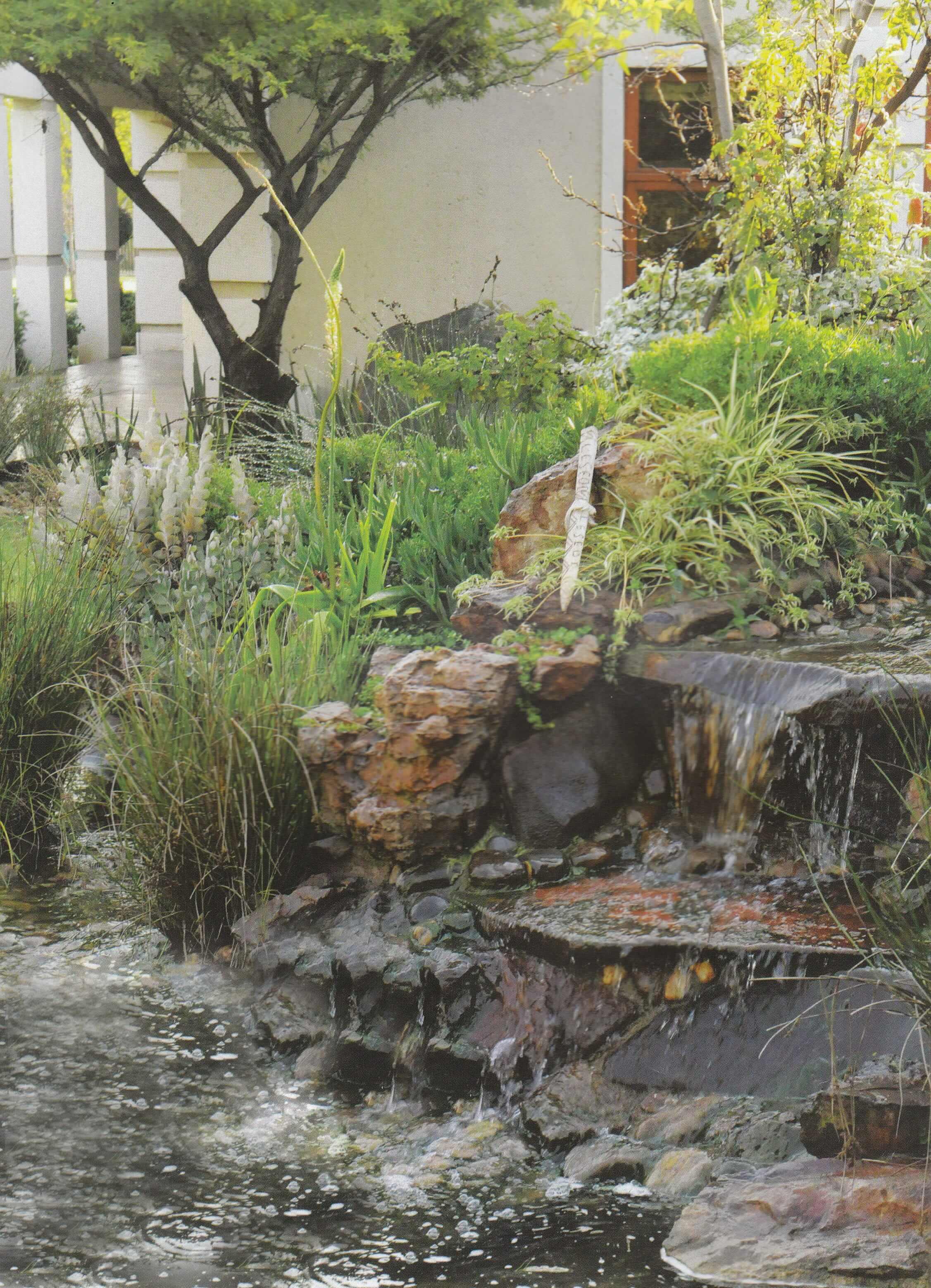 water feature with riverstone and rock boulders